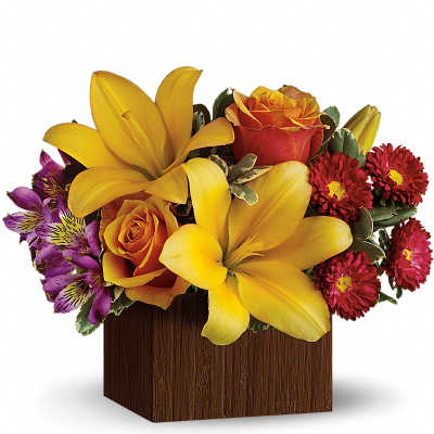Yellow lilies and orange roses in a wooden box with purple flowers