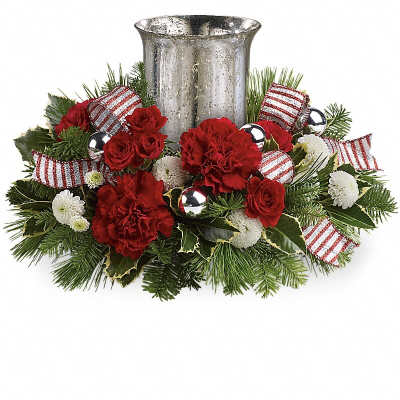 Holiday floral centerpiece with red flowers and a silver candle holder