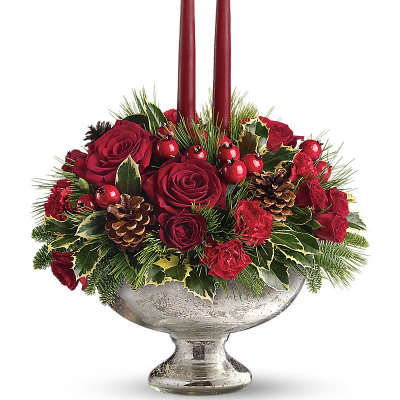 Red rose arrangement with two burgundy candles in a silver pedestal bowl