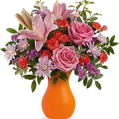 Pink roses and lilies in an orange vase