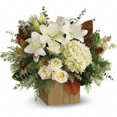 White lilies and roses arranged in a wooden cube vase