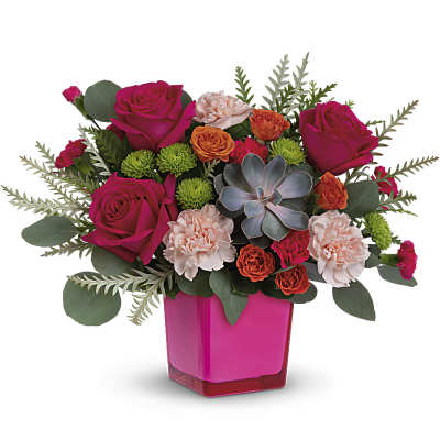 Pink and orange floral arrangement in a magenta vase