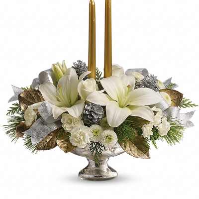 White floral centerpiece with two gold candles in a silver bowl vase