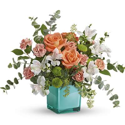 Peach roses and white alstroemeria in a turquoise vase