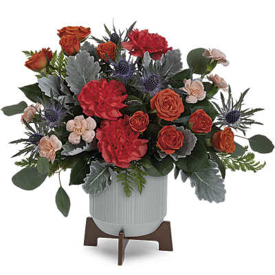 Orange roses and red carnations in a white vase