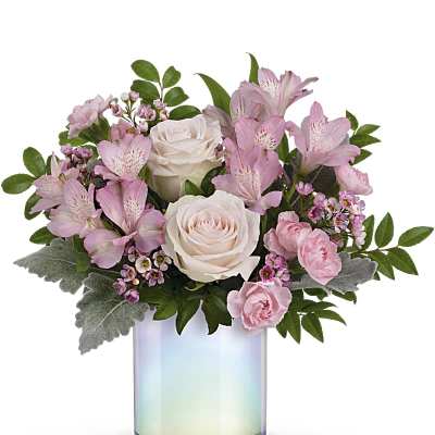 Pink and white flower arrangement in an iridescent glass vase