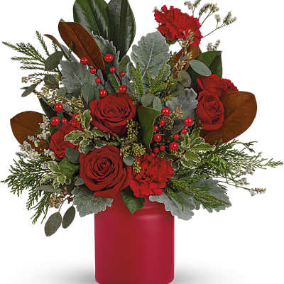 Red roses and carnations in a red vase with mixed greenery
