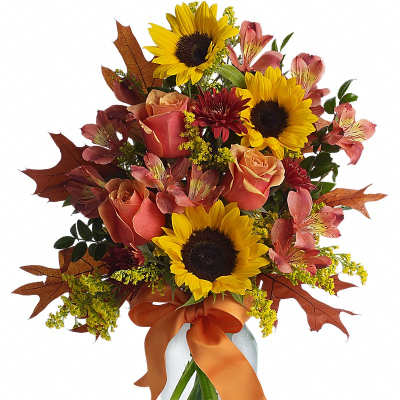 Bouquet of sunflowers, roses, and alstroemeria in a glass vase