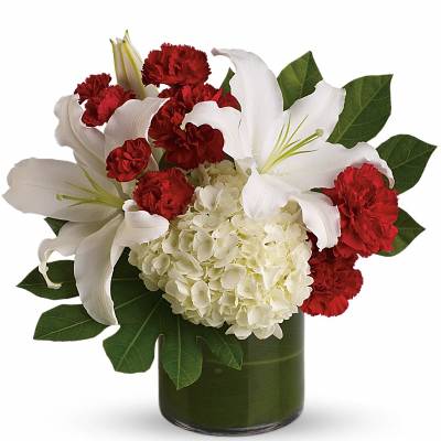 White lilies and red carnations in a green glass vase