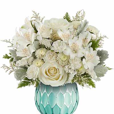 White floral arrangement in a turquoise patterned vase