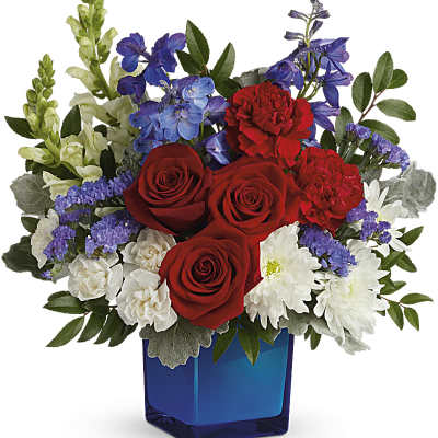Red roses and white daisies in a blue glass vase