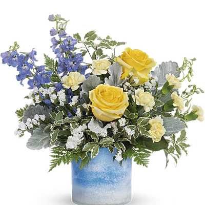 Yellow roses and blue delphinium in a blue glass vase