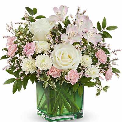 Pink and white bouquet in a green glass vase