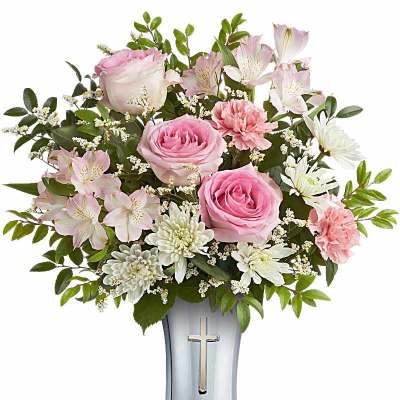 Pink roses and white flowers in a silver vase with a cross
