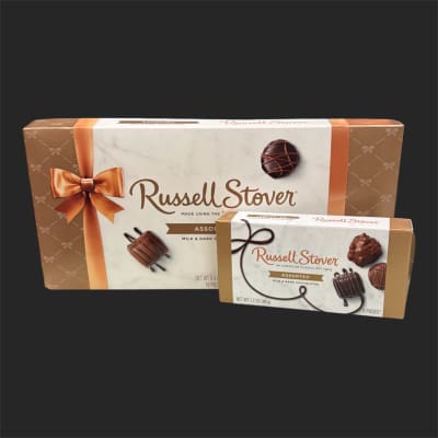 Two boxes of assorted chocolates on a dark background