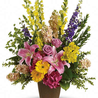 Mixed bouquet in a brown vase with pink lilies, roses, and yellow flowers