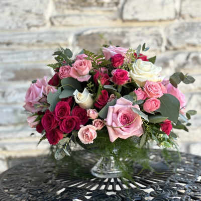 Pink and red rose bouquet in a clear glass vase
