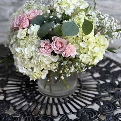 Pink roses and white hydrangeas in a glass vase