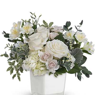 White and blush bouquet in a clear square vase