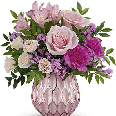 Pink roses and alstroemeria in a pink glass vase