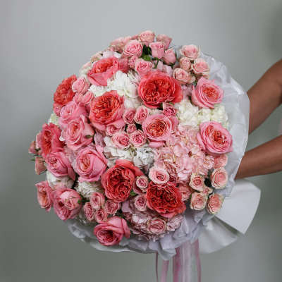 Large pink and white rose bouquet wrapped in white paper
