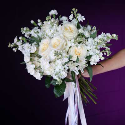 White rose bouquet with small white filler flowers and ribbon streamers