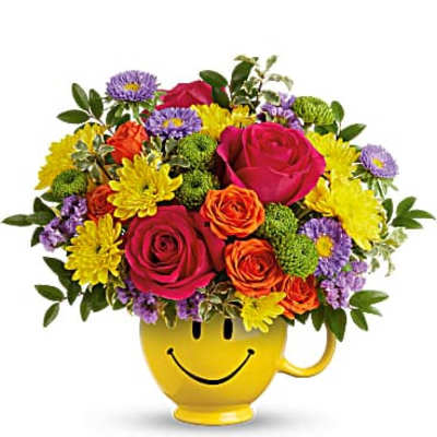 Colorful bouquet in a yellow smiley-face mug