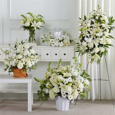 White floral arrangements in vases and a standing spray