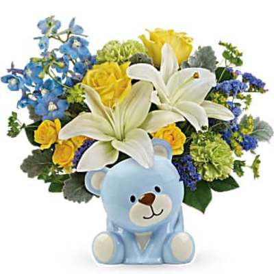 Bouquet of white lilies, yellow roses, and blue flowers with a teddy bear