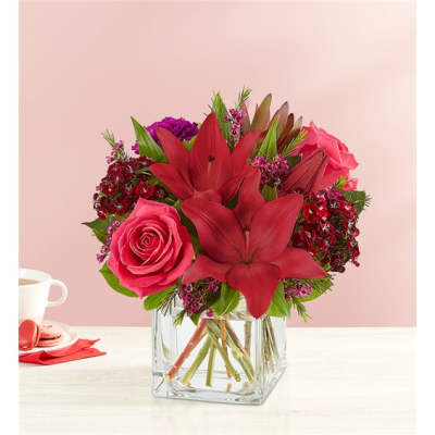 Pink and red floral arrangement in a clear glass vase