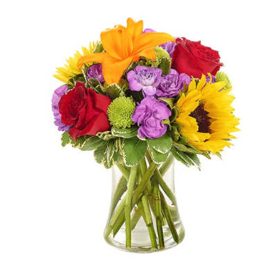 Bouquet of sunflowers, red roses, and purple blooms in a clear glass vase