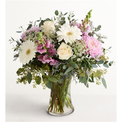 Bouquet of white and pink flowers in a clear glass vase