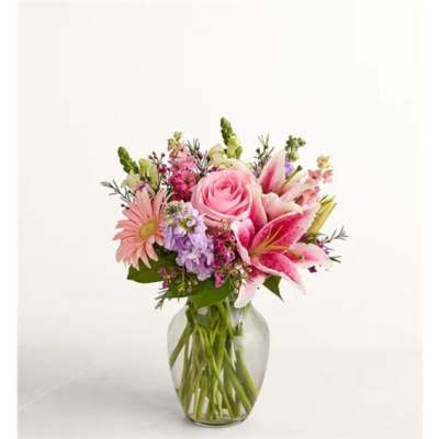 Pink mixed flower bouquet in a clear glass vase