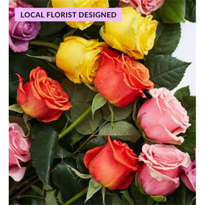 Close-up bouquet of multicolored roses with dark green foliage