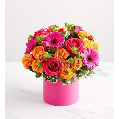 Bouquet of pink, orange, and yellow flowers in a pink vase