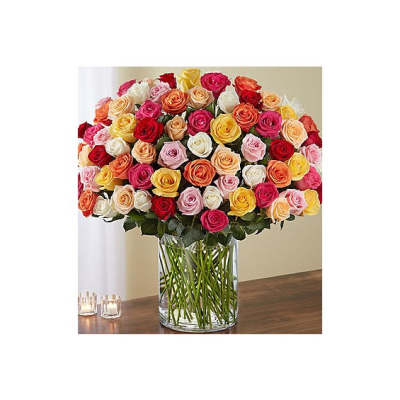 Large bouquet of multicolored roses in a clear glass vase