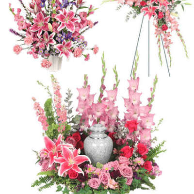 Pink lilies and roses arranged around a silver urn with matching standing sprays