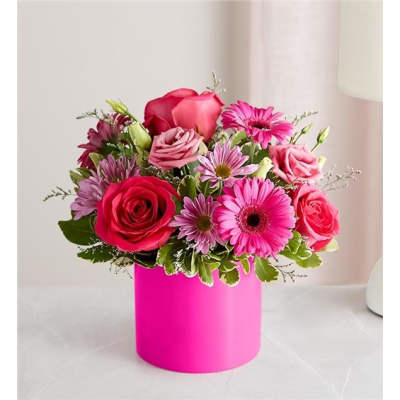 Pink and red mixed bouquet in a bright pink box vase
