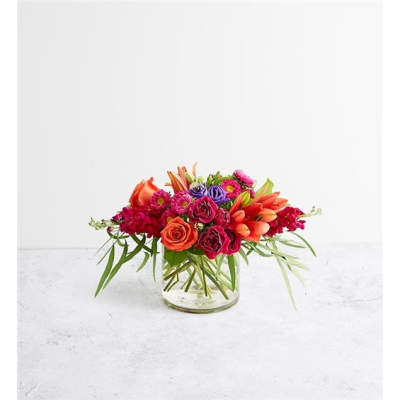 Bright mixed flower arrangement in a clear glass vase