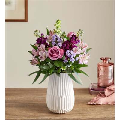 Pink and purple mixed bouquet in a white vase