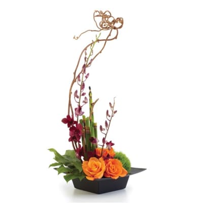 Orange roses and purple orchids in a black rectangular vase