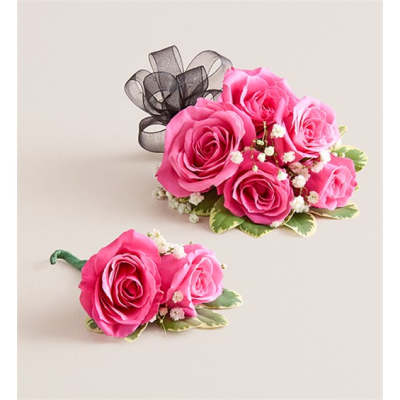 Pink rose corsage and matching boutonniere with black ribbon