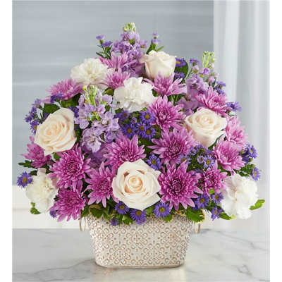 Pink and white flowers arranged in a patterned basket