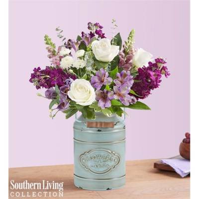 Bouquet of white roses and purple flowers in a pale blue metal container
