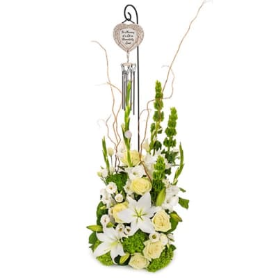 Tall white and green floral arrangement with a hanging memorial ornament