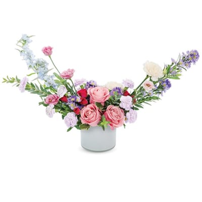 Pink and lavender flower arrangement in a white vase