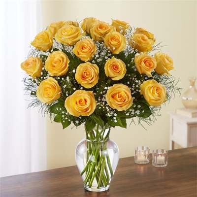 Yellow roses arranged in a clear glass vase