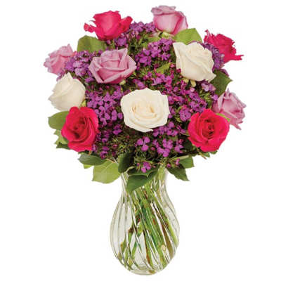 Bouquet of pink, white, and red roses in a clear glass vase