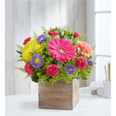 Colorful mixed flower arrangement in a wooden box