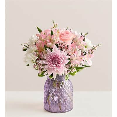 Pink and white mixed bouquet in a purple textured vase